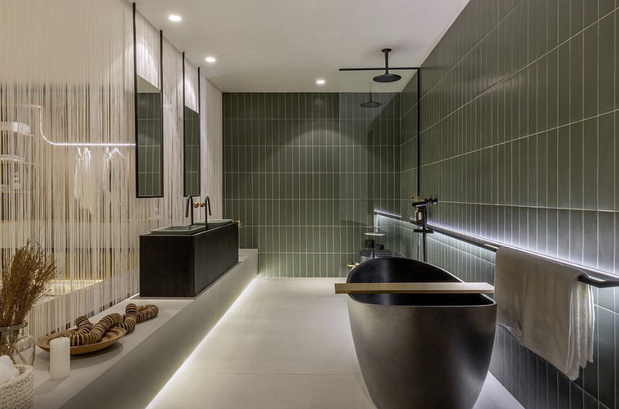 Banheiro de alto padrão com banheira moderna, iluminação indireta e design arquitetônico sofisticado.